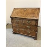 A walnut and feather banded bureau in the early 18th century manner,
