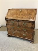 A walnut and feather banded bureau in the early 18th century manner,