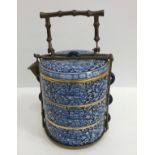 A 20th Century Thai blue and white and gilt decorated tiffin in three sections with all over