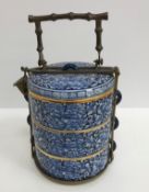 A 20th Century Thai blue and white and gilt decorated tiffin in three sections with all over