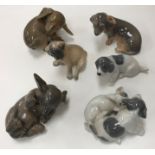 A collection of six various Royal Copenhagen dog / puppy figures including "Puppy chasing tail"