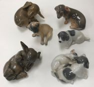 A collection of six various Royal Copenhagen dog / puppy figures including "Puppy chasing tail"