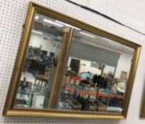 A modern gilt swept framed rectangular wall mirror with bevel edged plate, 99 cm x 69 cm,