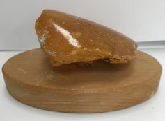 An uncut natural amber section polished to one side 9 cm high x 7.5 cm wide x 3.