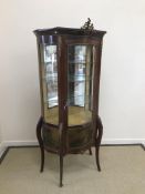 A mahogany vitrine in the Louis XV taste with gilt brass embellishments and Vernis Martin panels,