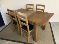 A modern oak extending dining table on s