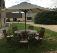 A teak garden table together with a crea
