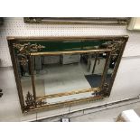 A gilt framed rectangular wall mirror in
