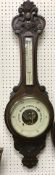 An oak cased barometer thermometer in th