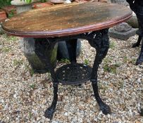Two cast iron pub tables with wooden top