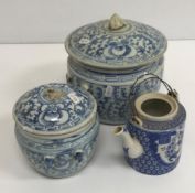 An Oriental blue and white decorated lidded pot with twin handles 22 cm high x 20 cm diameter