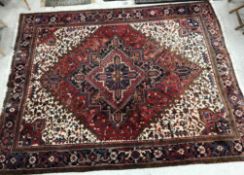 A Heriz rug, the central panel set with