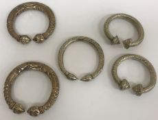 Two pairs of white metal slave bangles /