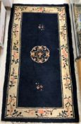 A vintage Chinese rug, the central panel