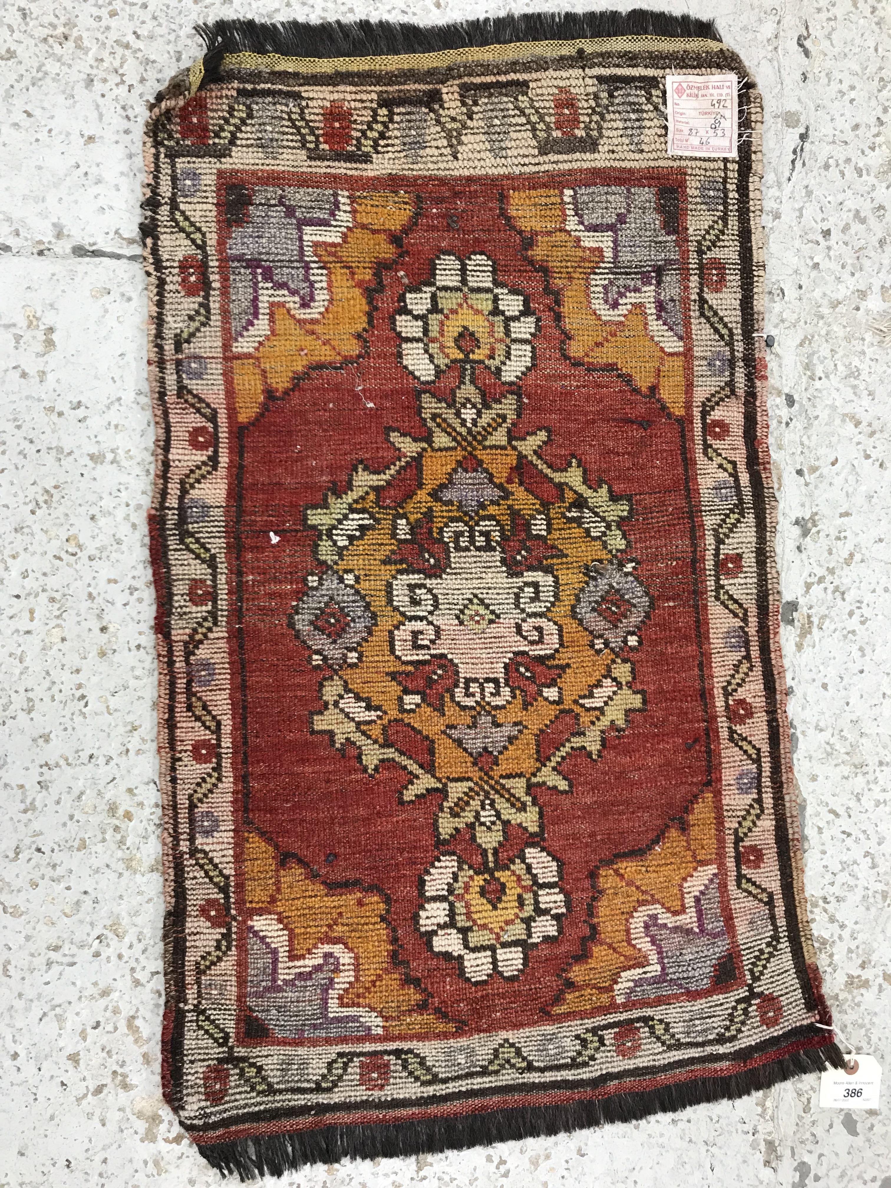 A Turkish rug, the central panel set wit - Image 2 of 3