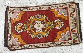 A Turkish rug, the central panel set wit
