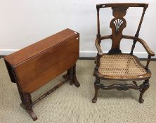 An early 20th Century oak and beech caned low elbow chair, 82 cm high,