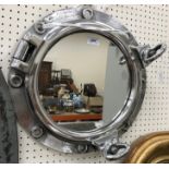 A modern chrome effect port hole style mirror,