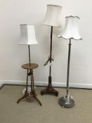 A collection of three various standard lamps including a mahogany pole screen conversion,