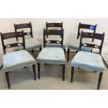 A set of six early Victorian mahogany bar back dining chairs with oval medallion decorated back