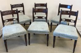 A set of six early Victorian mahogany bar back dining chairs with oval medallion decorated back