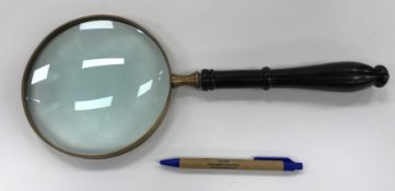 A large modern table magnifying glass with ebonised handle, the glass 15.5 cm diameter, 37.