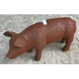 Two cast metal figures of pigs, with rust style patination,