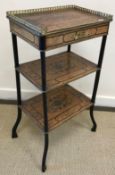 A circa 1900 French walnut and marquetry three tier étagère with galleried top and single drawer,
