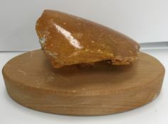 An uncut natural amber section polished to one side 9 cm high x 7.5 cm wide x 3.