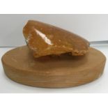 An uncut natural amber section polished to one side 9 cm high x 7.5 cm wide x 3.