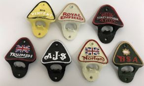 A collection of seven various cast metal bottle openers,