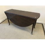 A 19th Century mahogany oval drop-leaf dining table, the top with plain moulded edge,