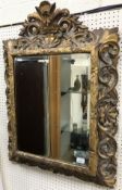 A 19th Century carved oak and gesso decorated Florentine style wall mirror with bevel edged plate,