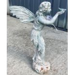 A cast metal figure of a fairy holding a bird in her hand, with verdigris style patination,