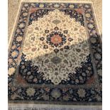A large Indo-Persian wool carpet, the cream ground with central red brick and floral medallion,