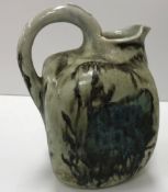 A late 19th Century Martin Brothers pottery jug of square form with fish decoration,