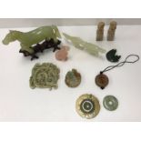 A collection of various Chinese hard stone ornaments including a figure of a horse,