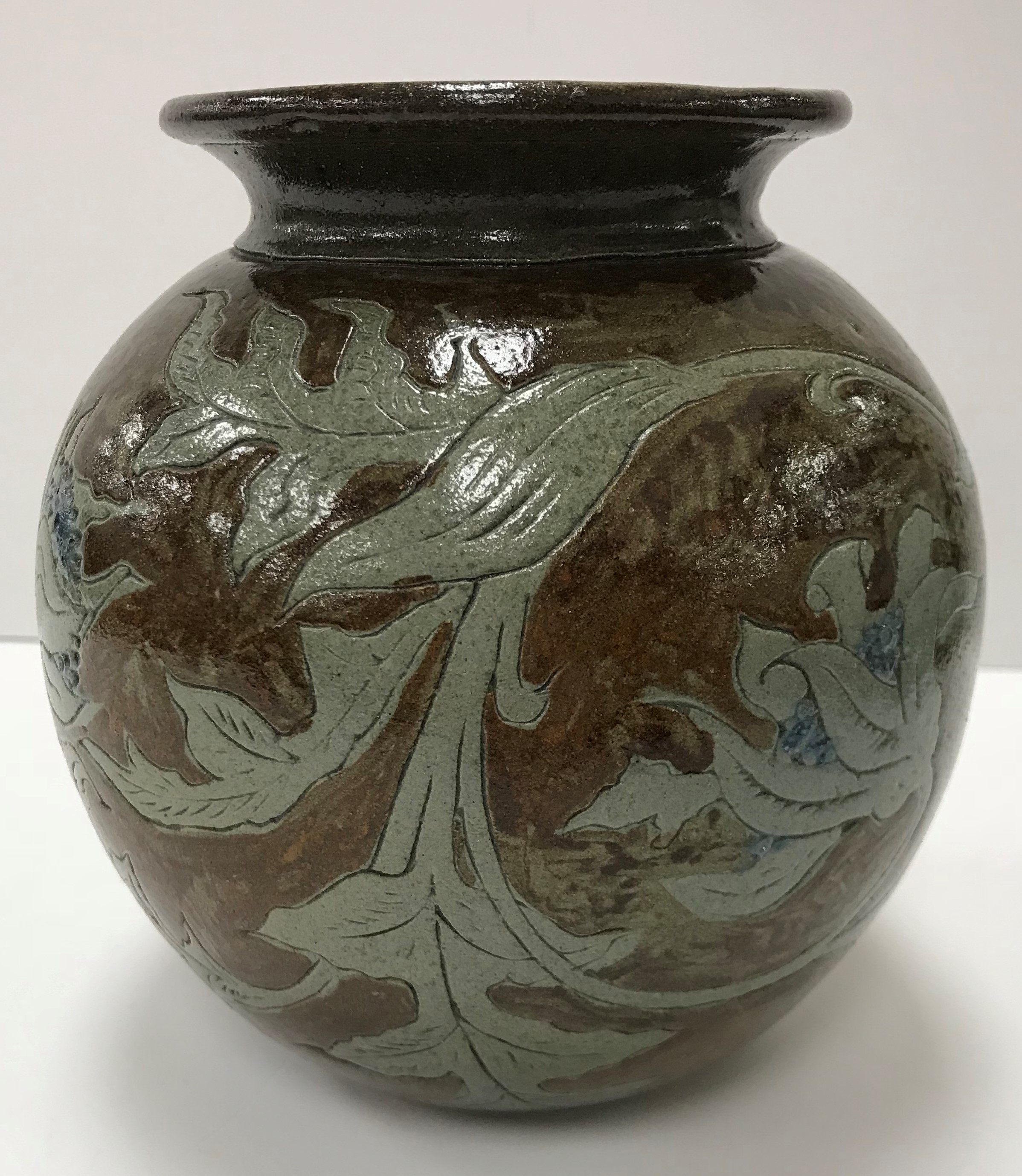 A late 19th Century Martin Brothers pottery vase with foliate decoration,