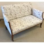 An Edwardian mahogany and inlaid two seat salon sofa on square tapered legs to castors,