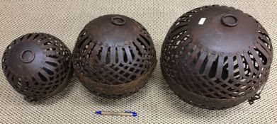 A set of three graduated metal spherical "candle" cages, each with hanging loop, 21.5 cm, 24.