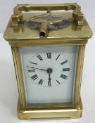 A circa 1900 French lacquered brass cased carriage clock, the enamelled dial with Roman numerals,