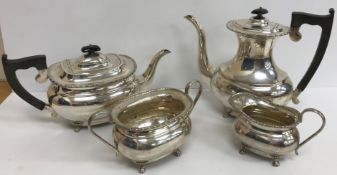 A silver four piece tea set comprising tea pot, water jug,