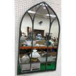 A small modern wall mirror in the Gothic arched syle,