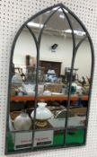A small modern wall mirror in the Gothic arched syle,