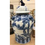 A modern blue and white Chinese vase and cover decorated with horses in a landscape,