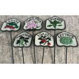 A collection of twelve painted cast metal salad / vegetable signs inscribed "Radish", "Spinach",
