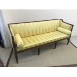 A Regency mahogany sofa, the show frame with reeded decoration, the upholstered back,