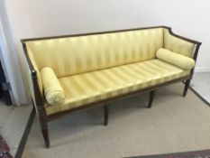 A Regency mahogany sofa, the show frame with reeded decoration, the upholstered back,