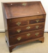 A 19th Century oak bureau, the fall front enclosing a basic fitted interior,