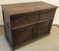 A 19th Century oak enclosed dresser, the plain top above two drawers and two cupboard doors,
